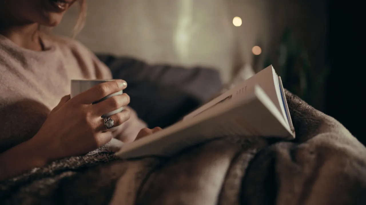 Holding an open book in warm light